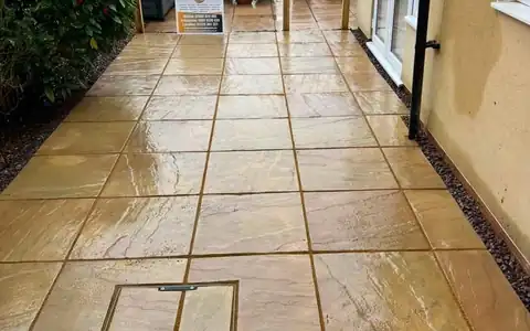 Sandstone patio path beside a house