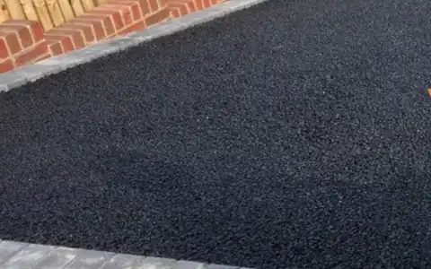 Freshly laid tarmac driveway with block paved edging