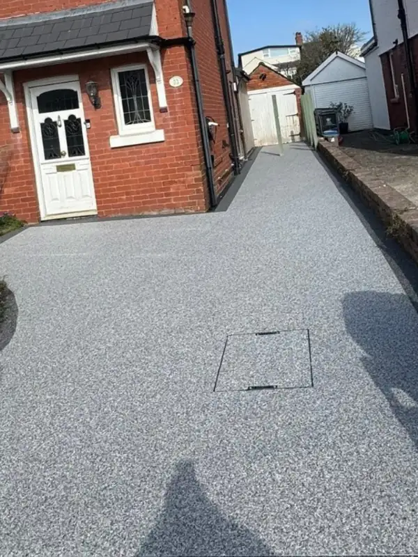 Resin bound driveway in front of a white garage