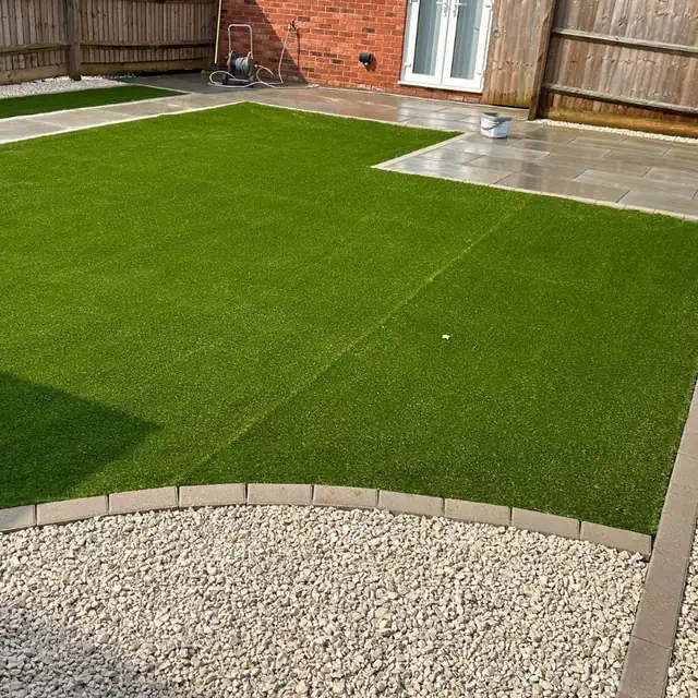 Artificial lawn with a patio and gravel border