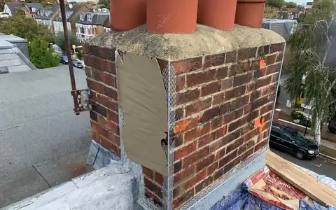 Chimney stack being rebuilt with new pots