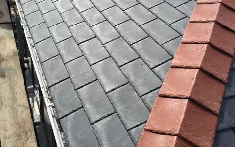 New ridge tiles on a grey tiled roof